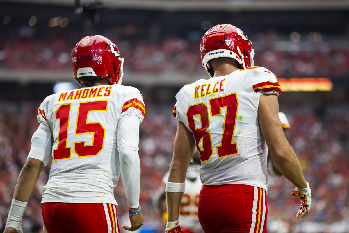 Patrick Mahomes and Travis Kelce walk onto the field during a Chiefs game